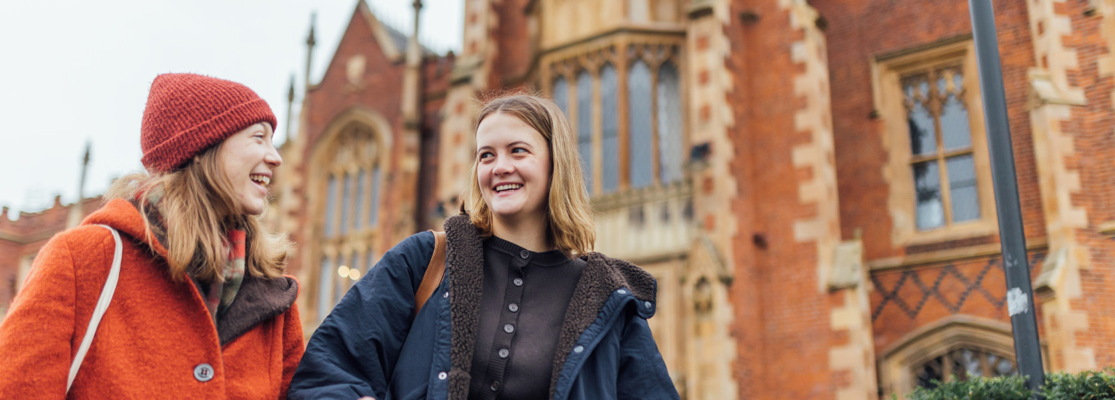 Students Lana and Tessa walking past the Lanyon