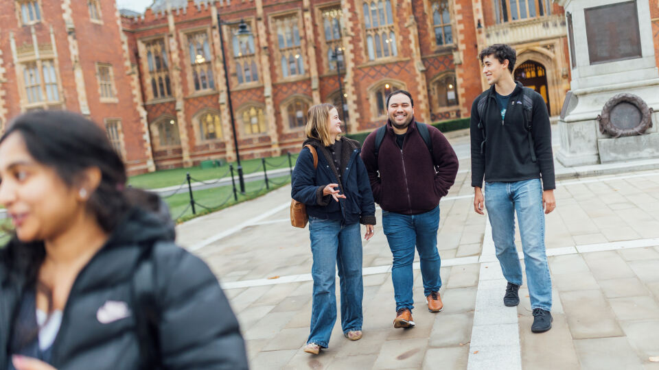 Three students walking away from the Lanyon
