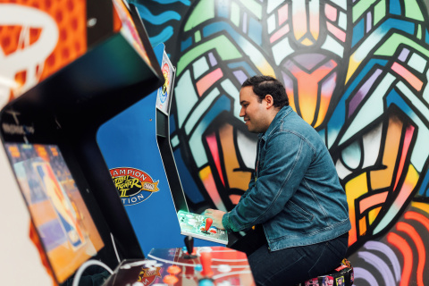 Student Miguel plays arcade games in Reboot Cafe