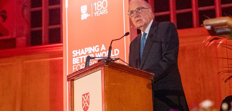 Close-up of Senator George Mitchell at the podium addressing the 'Passing The Torch' event at Queen's University Belfast