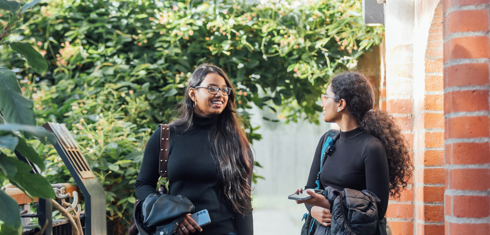 Two female students walk through Tropical Ravine