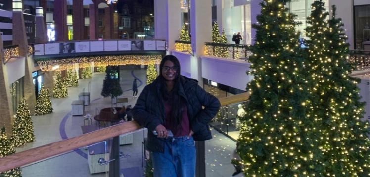 Student Natasha stands beside Christmas tree in Victoria Square