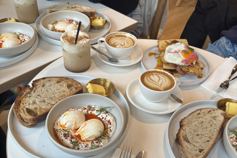 Plates of brunch food and coffee on table in Neighbourhood Cafe