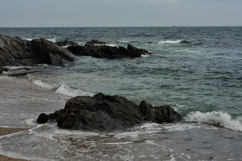 Waves against rock on Newcastle beach