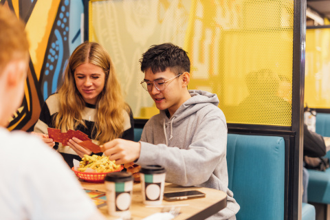 Two students eating chips in Reboot Cafe
