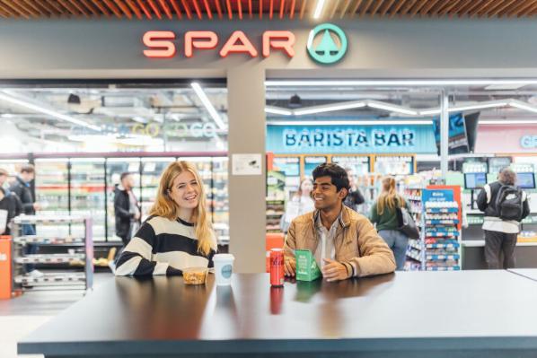 Students Niamh and Christy sit outside the Spar in One Elmwood