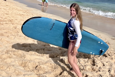 Student Niamh on beach with surf board