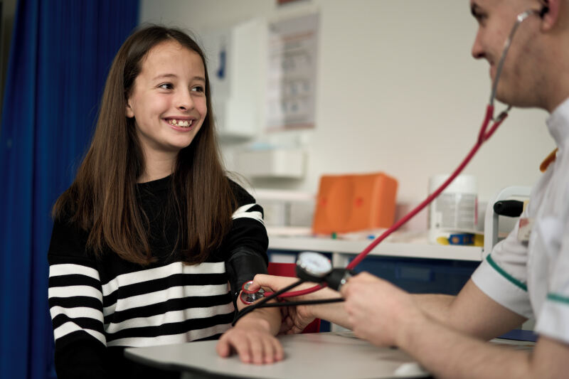 Nursing student treating child patient