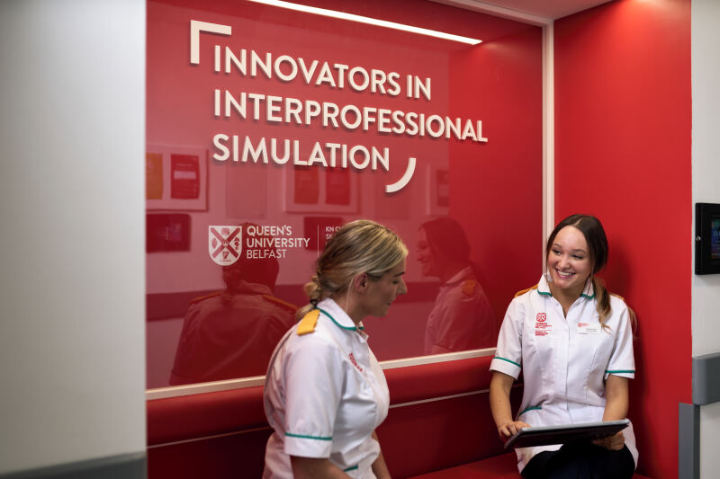 Uniformed students chatting at Intersim seated pods