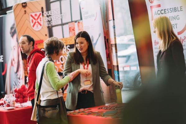People gather at an Offer Holder Day information stand