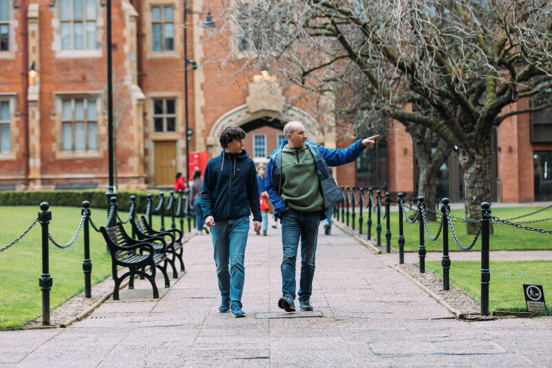 Parent and student walk through Queen's Quad