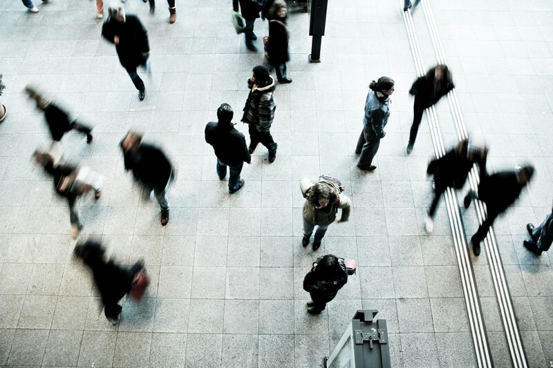 Blurry people walking through a busy part of a city