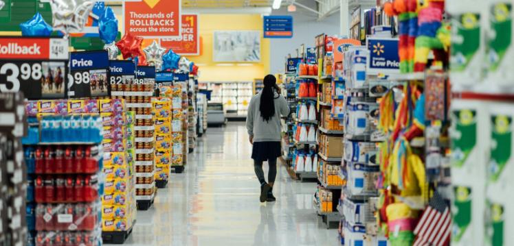 Person walking down aisle in supermarket