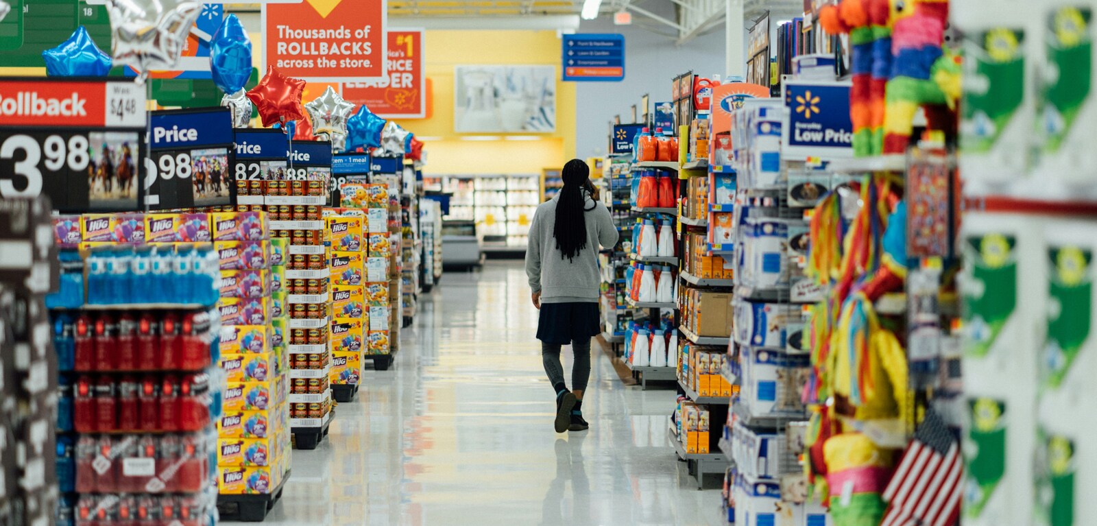 Person walking down aisle in supermarket