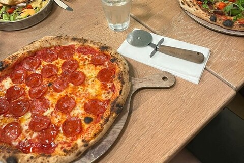 Pizza and pizza cutter on a table in Orto Belfast