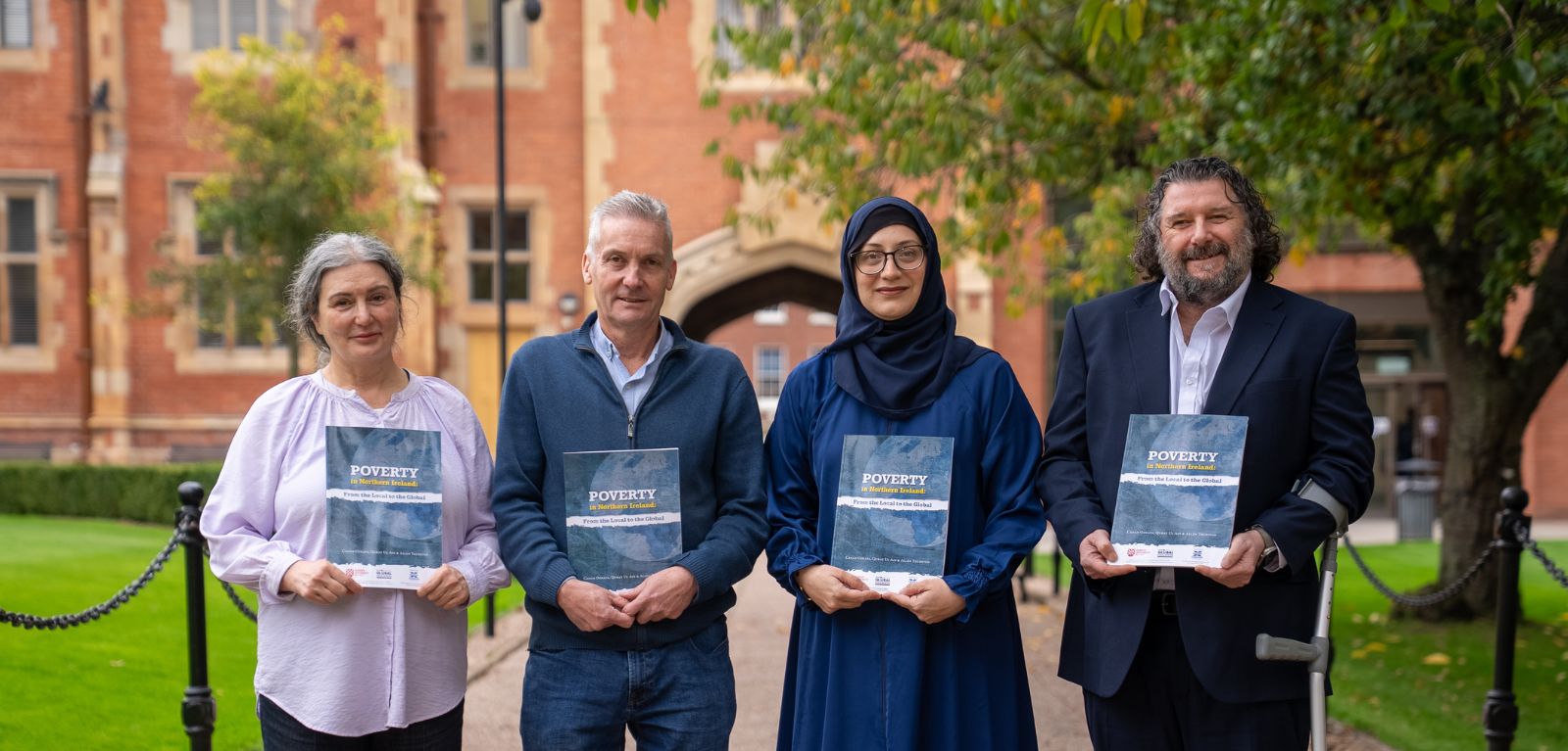 People standing in a row holding the poverty report