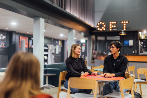 Students Lucas and Tessa sit in the QFT foyer
