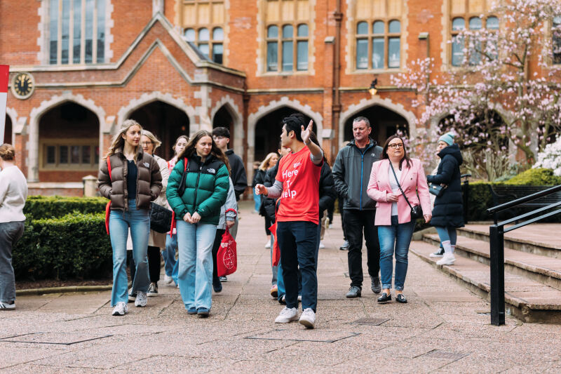 Group of offer holders walk through the quad