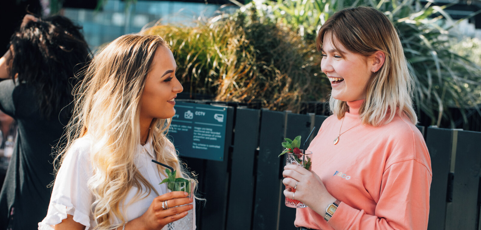 Two female students having a drink outside in Belfast