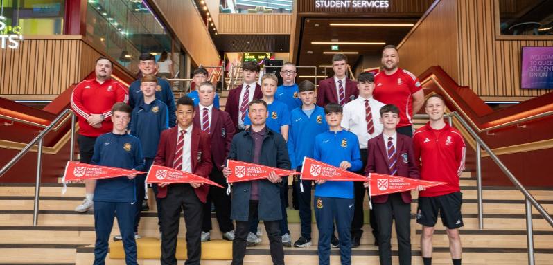 Students from Queen's Junior Sports Academy celebration event. Pictured on stairs of One Elmwood with Carl Frampton