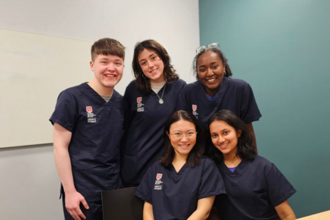 Medicine student Radhika with fellow students in scrubs