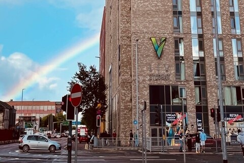 Rainbow behind student accommodation building in Belfast