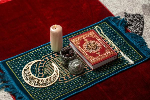 Ramadan prayer book and candle