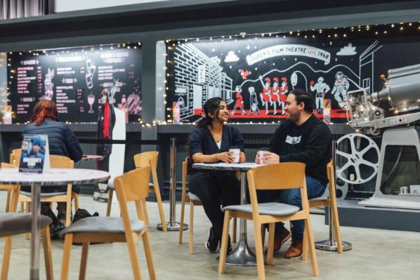 Students Sanjana and Miguel sitting in the QFT foyer
