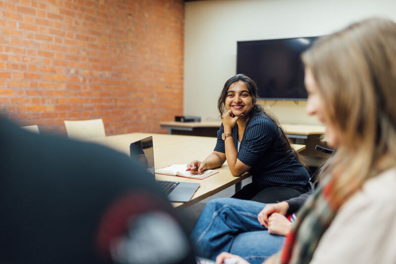 PGT student Sanjana sitting in group study room inside the Graduate School