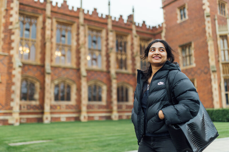 Student Sanjana walking past the Lanyon