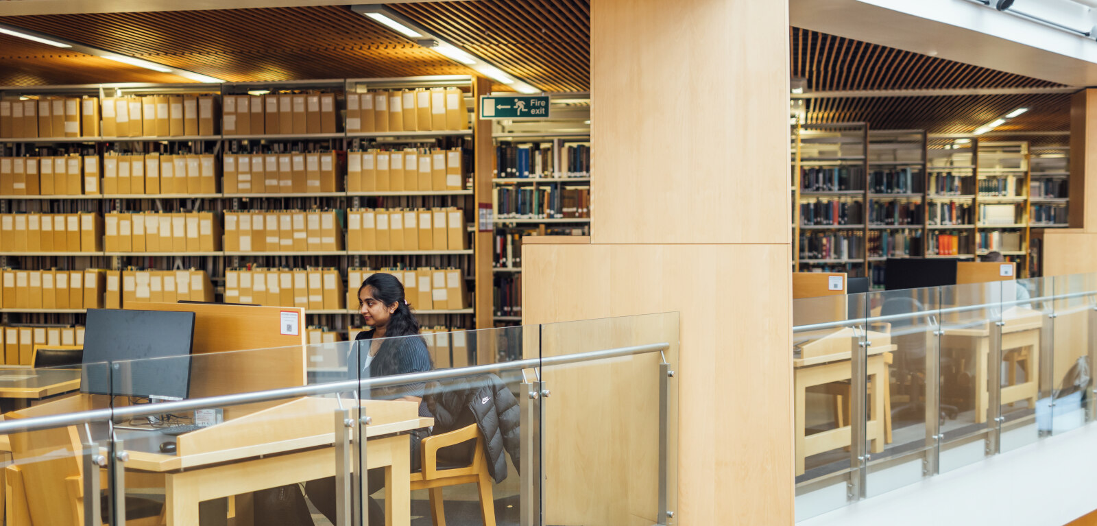 Female student at workstation in the McClay Library