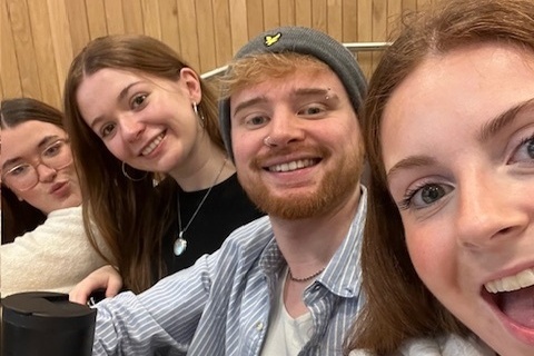Four Marketing students sitting in lecture hall