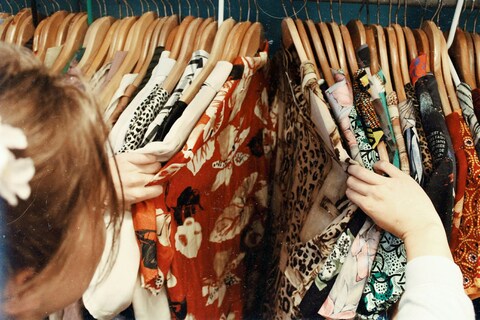 Person shopping for second hand clothes