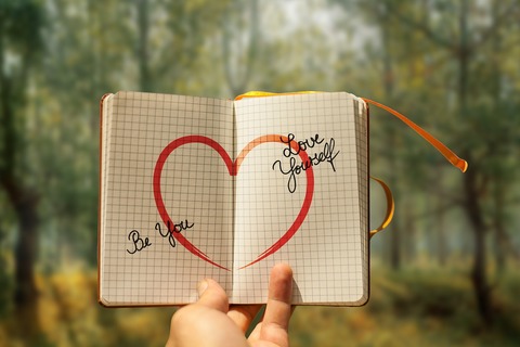 Notebook with heart and love yourself written on it