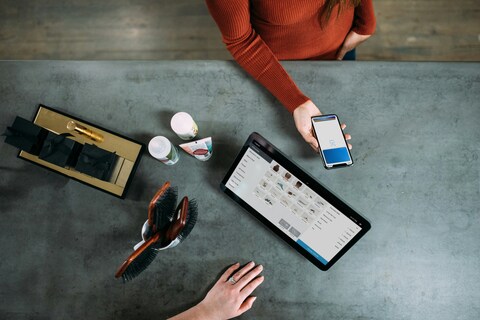 Woman paying for items at a check out