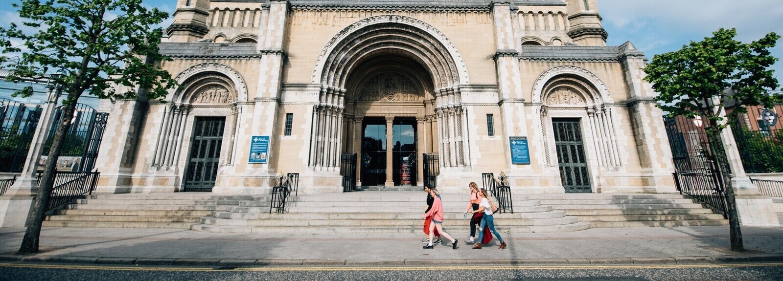 Group of students walking past entrance of St Annes Cathedral