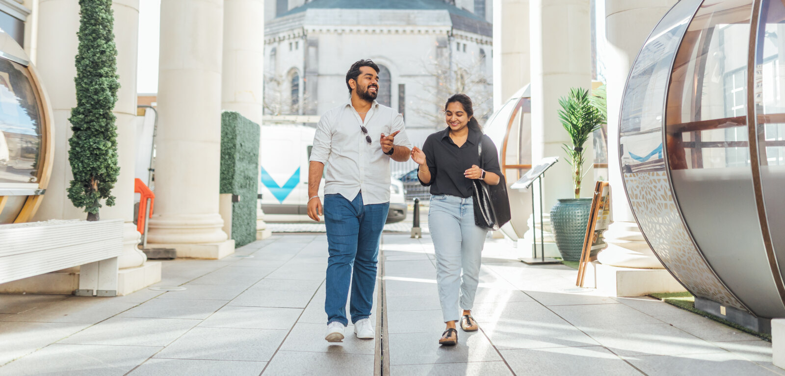 Two students walking through St Anne's Square