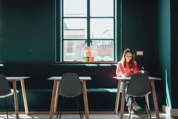 Student sitting in cafe alone