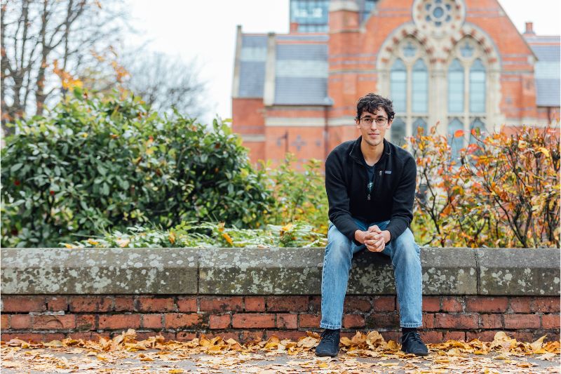 Student sitting on a wall