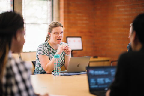 Students sitting at table in the Graduate School