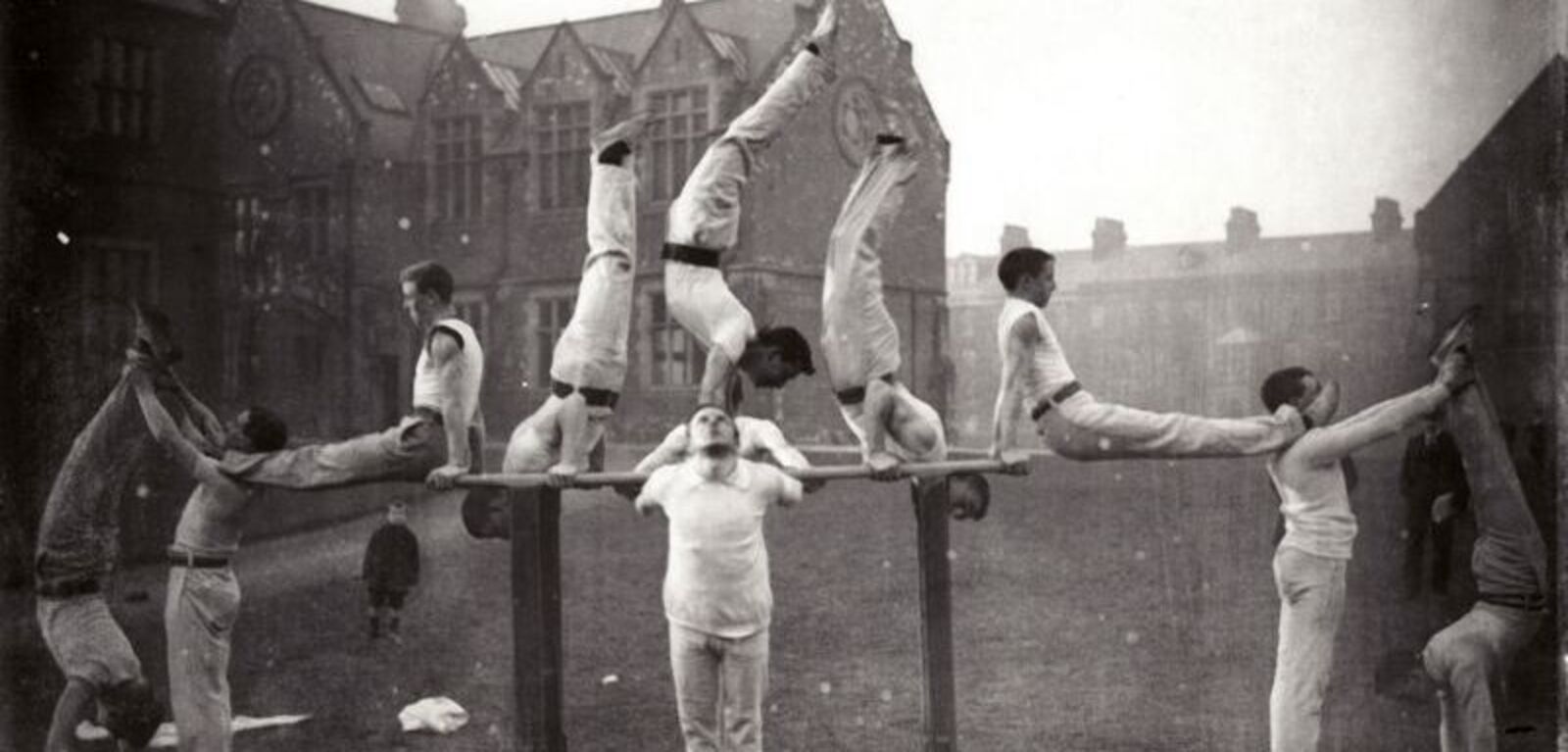Students perform gymnastics outside on the Quad