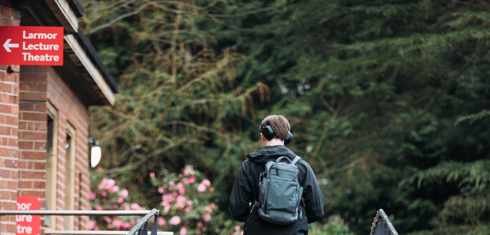 Student walking towards Larmor Lecture Theatre