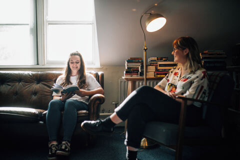 Two students having a conversation in the School of AEL