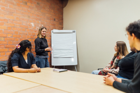 Students mind mapping in group room inside the Graduate School