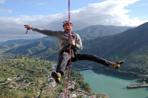 Student hanging from rope while mountaineering