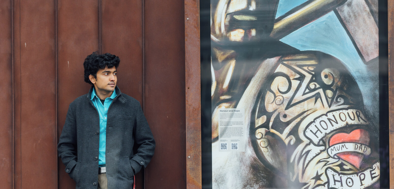 Student stands beside Terry Bradley artwork