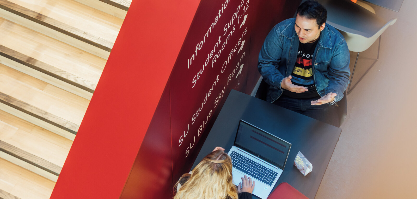 Two students sitting talking together in One Elmwood