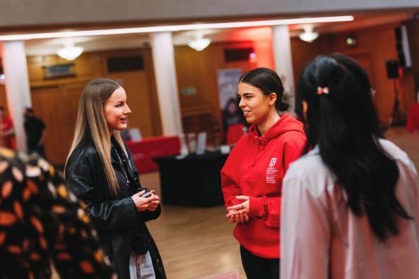 Students talking to staff member at offer holder event