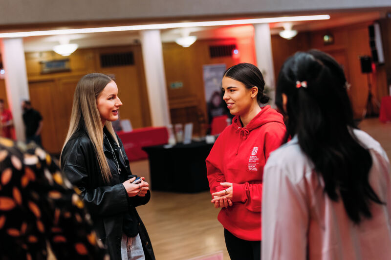Students talking to staff member at offer holder event