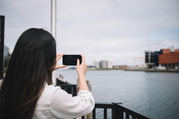 Student taking photo in Titanic Quarter